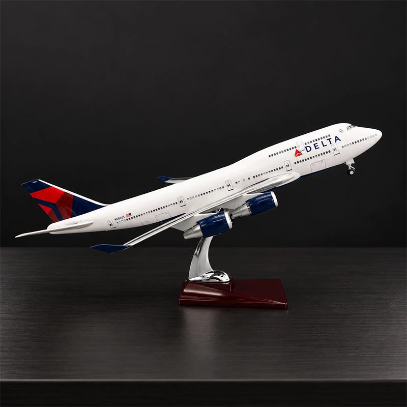 Delta Boeing 747 1:150 scale model airplane with open cabin interior and white LED lighting on a display stand.