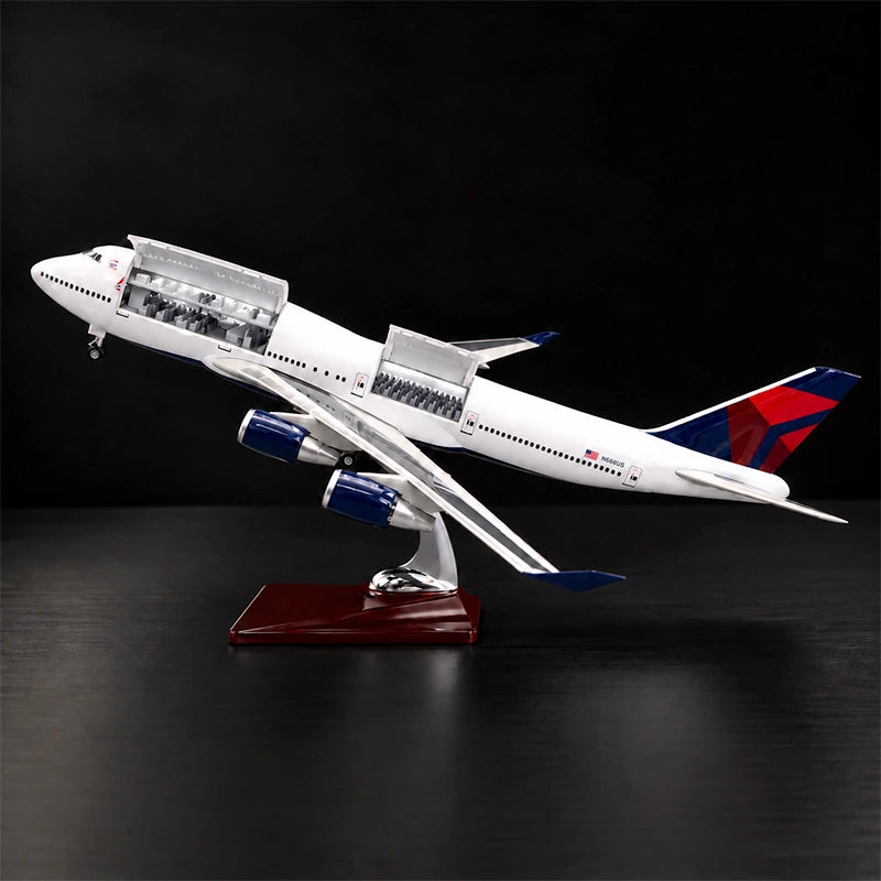 Delta Boeing 747 1:150 scale model airplane with open cabin interior and white LED lighting on a display stand.