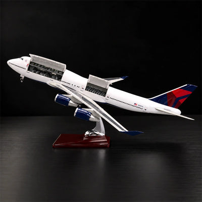 Delta Boeing 747 1:150 scale model airplane with open cabin interior and white LED lighting on a display stand.