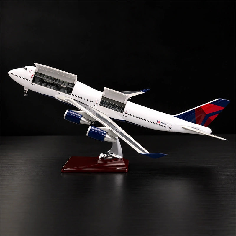 Delta Boeing 747 1:150 scale model airplane with open cabin interior and white LED lighting on a display stand.