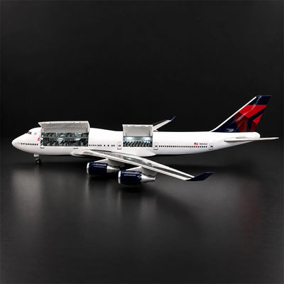 Delta Boeing 747 1:150 scale model airplane with open cabin interior and white LED lighting on a display stand.