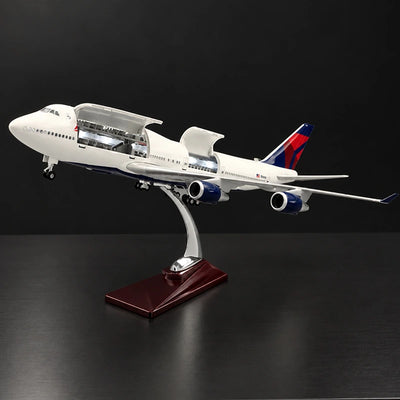 Delta Boeing 747 1:150 scale model airplane with open cabin interior and white LED lighting on a display stand.